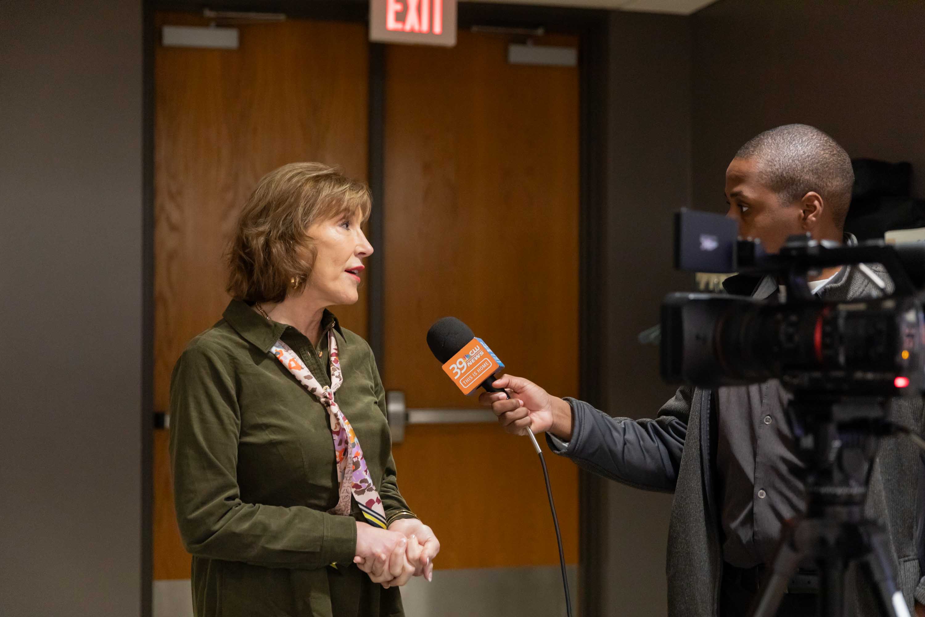 Jill Holland is talking with a news reporter at the Summit.